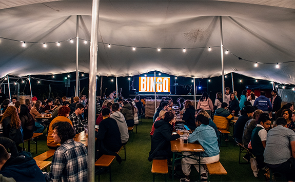 Students sat under a marquee playing bingo